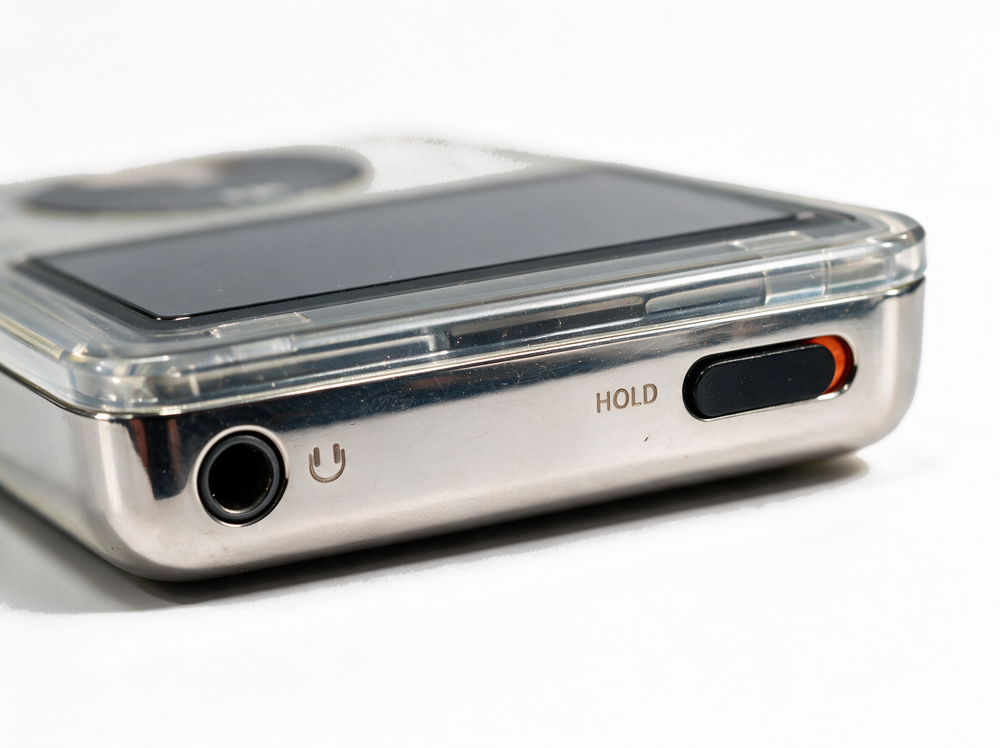 Ghost &mdash; top edge, headphone jack and hold switch, fully clear transparent iPod Classic.